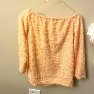 This does not have a tag . It is a light peach color off the shoulder sweater